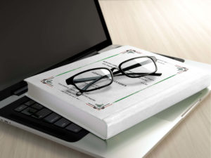 glasses on a book and computer